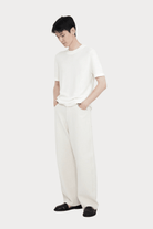 7115 By Szeki | Relaxed Curve Legged Trouser In Off-White - SHOP YUCCA Pants 7115 BY SZEKI - YUCCA, Women’s clothing store Denver, women’s clothing website, women’s elevated pants, clothing boutiques near me, women’s elevated trousers.