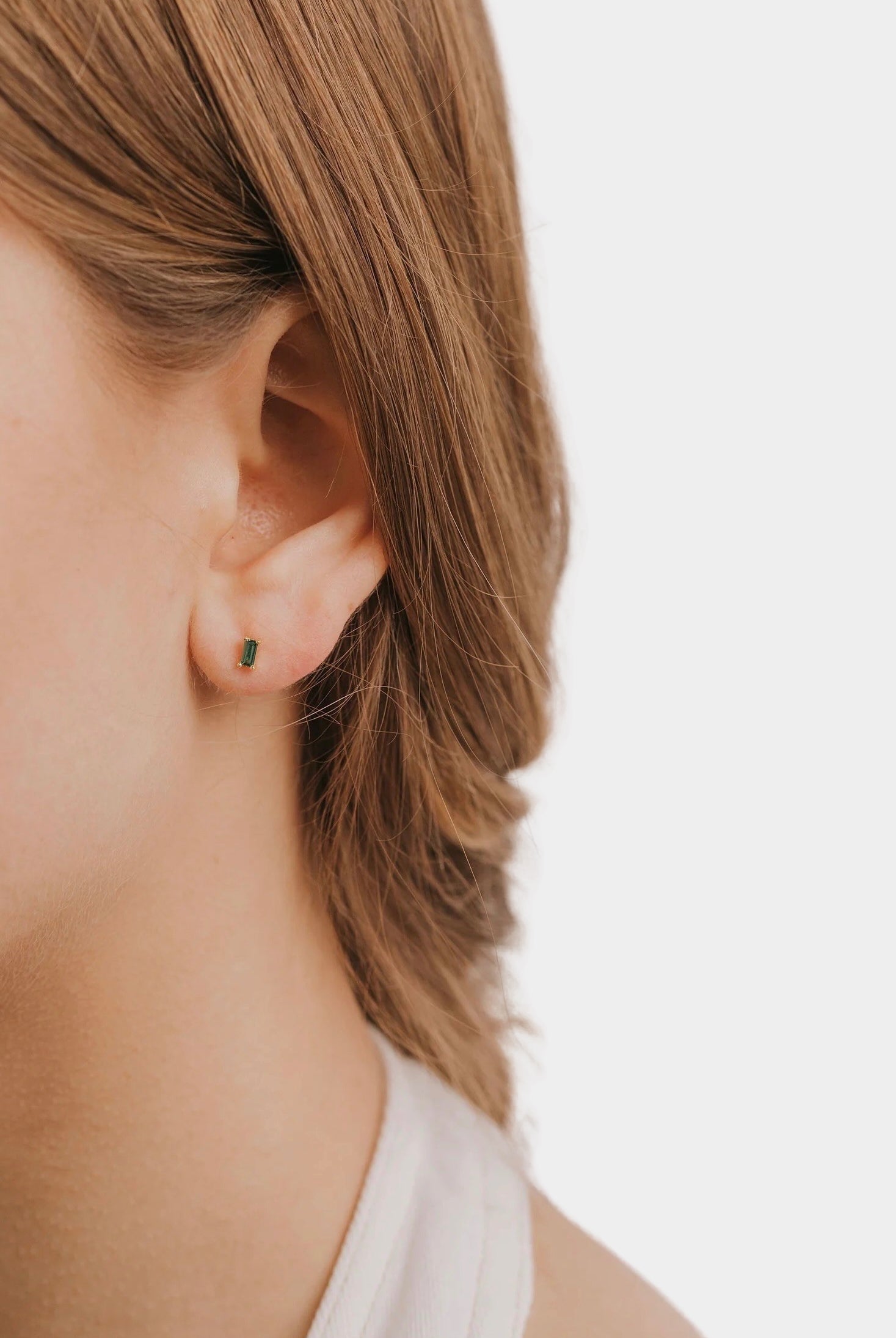 Earrings - YUCCA, emerald colored baguette stud earrings with gold plating and sterling silver posts.