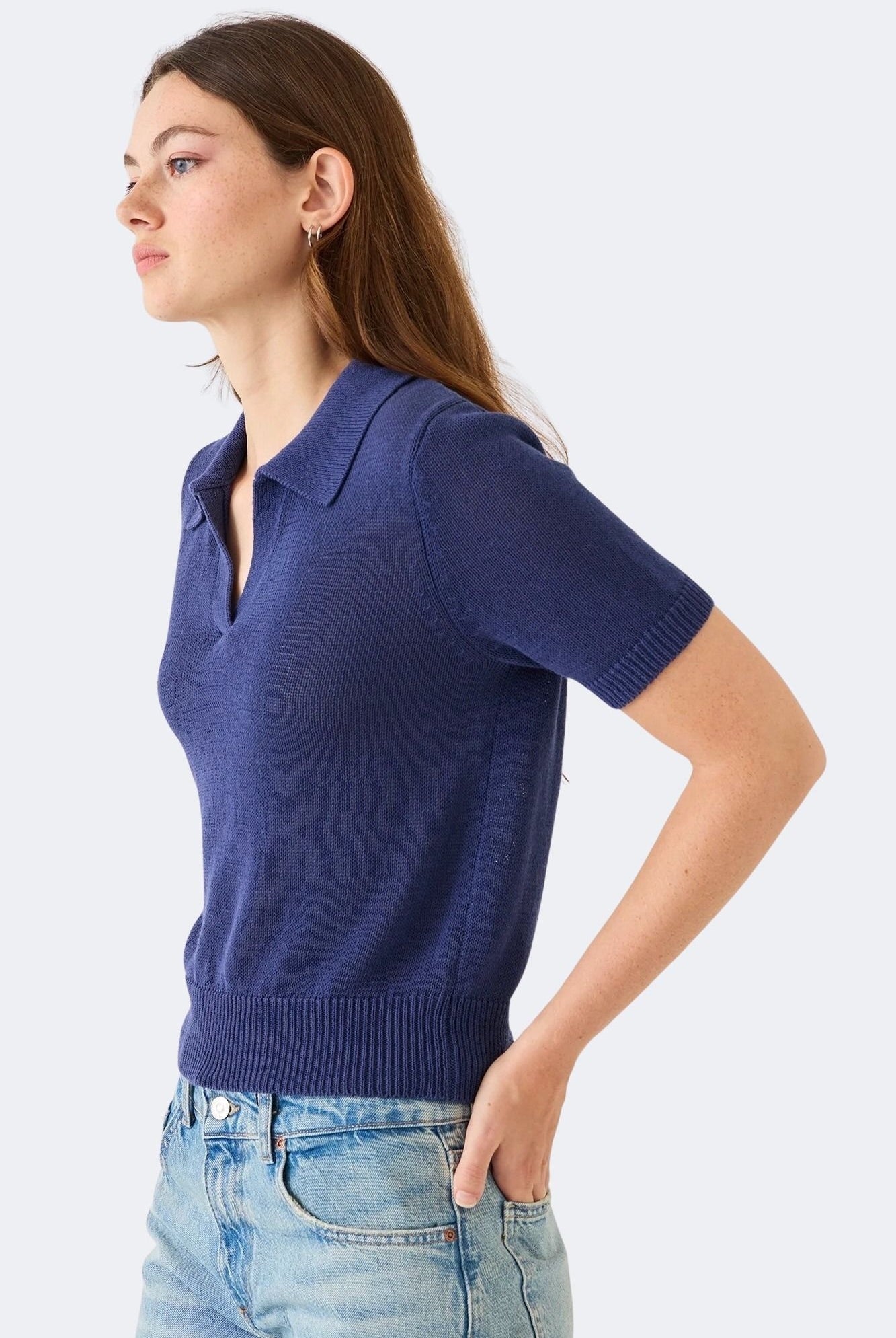 Model wearing DEMYLEE Cris indigo cotton linen knit polo top with slim fit and ribbed trim
