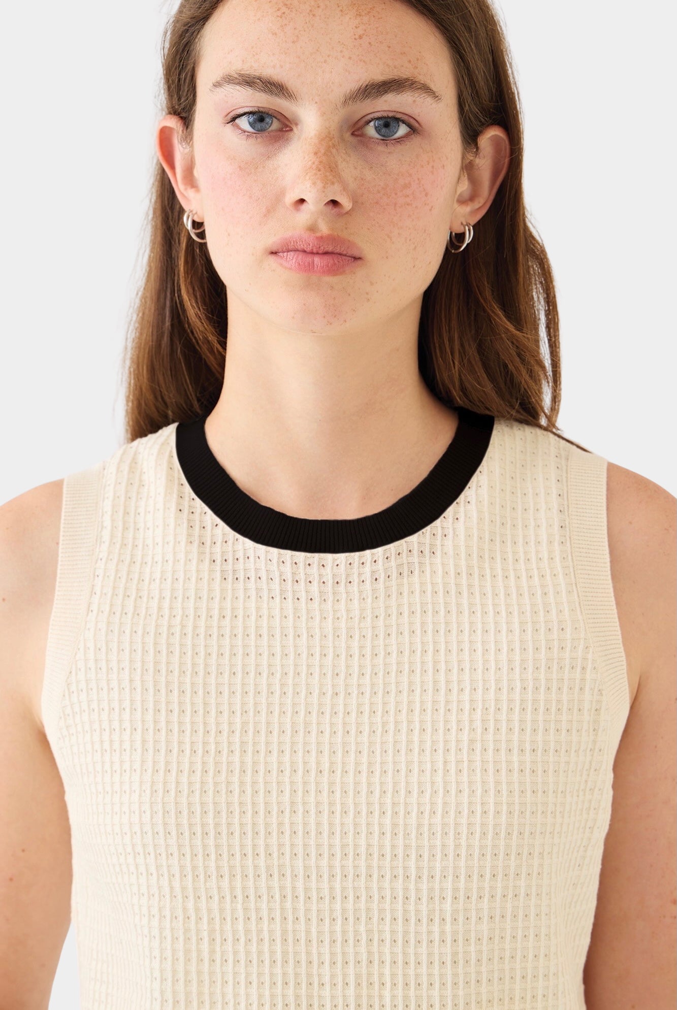 DEMYLEE Issa waffle pointelle cotton sleeveless knit top in ecru with black crewneck trim worn on model