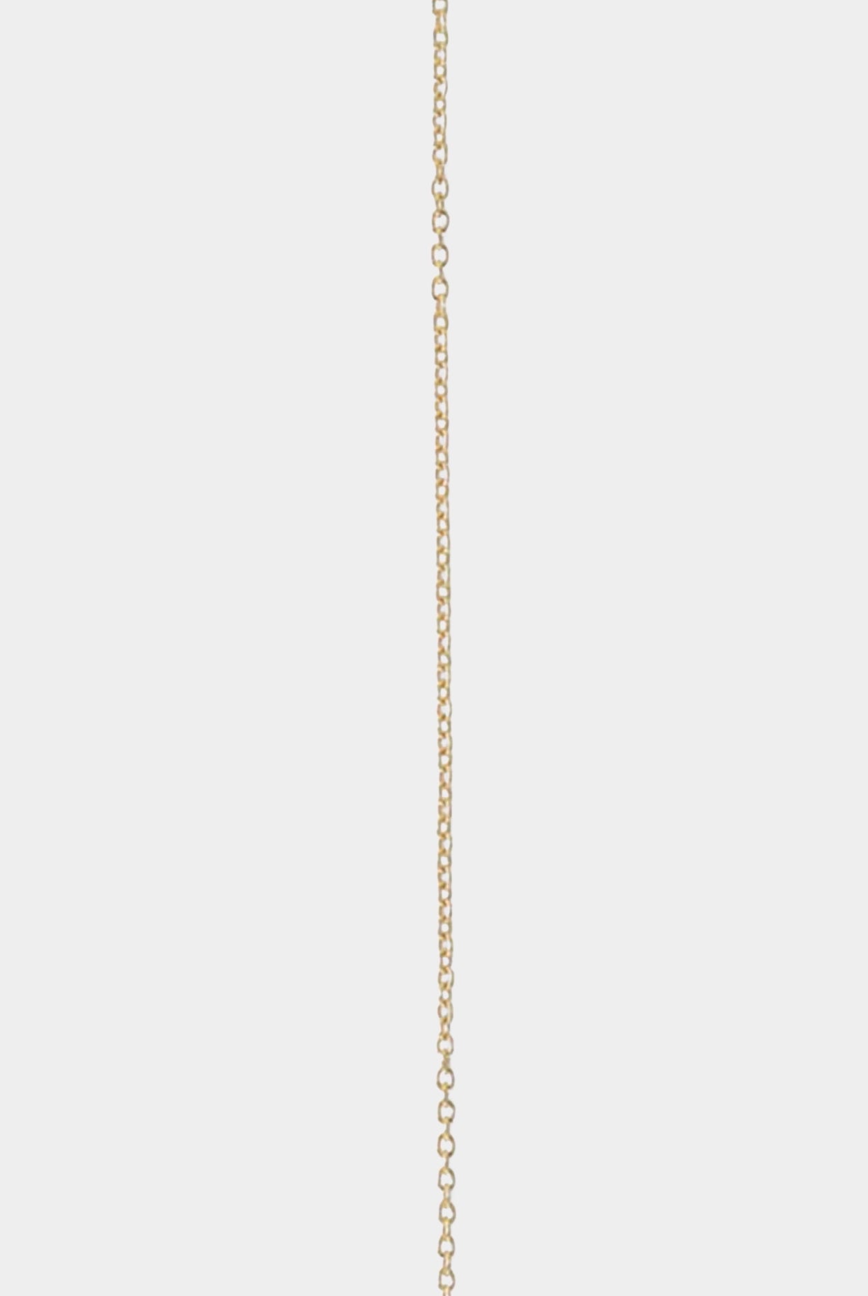 Close-up of fine 14k gold-filled chain necklace showing delicate link detail.