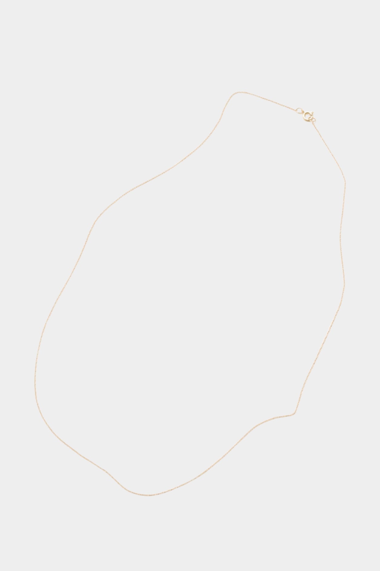 Minimalist 14k gold-filled chain necklace laid flat on neutral background.