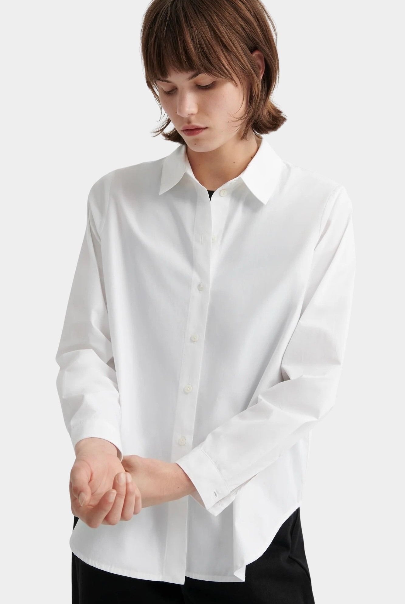Kowtow Daily Shirt in white close up showing relaxed fit and button placket