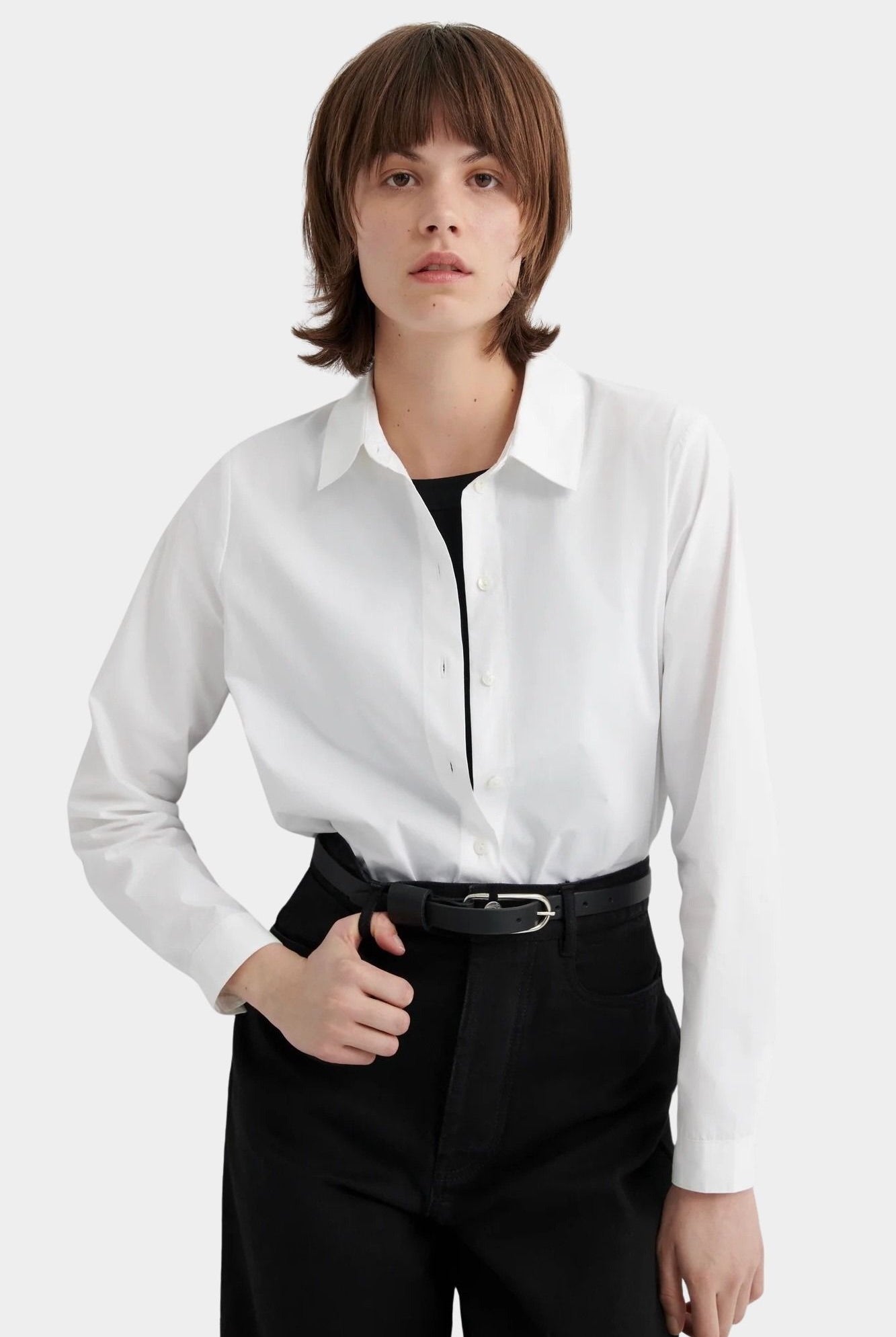 Kowtow Daily Shirt in white worn tucked into black trousers, front view
