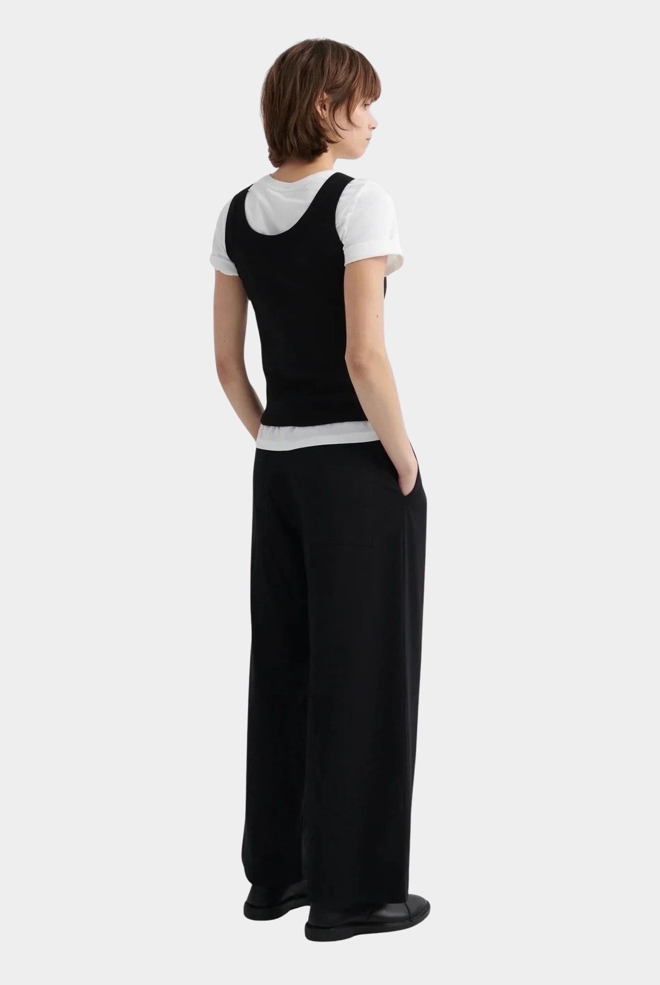 Kowtow Everyday Tank in black layered over white t shirt, back view