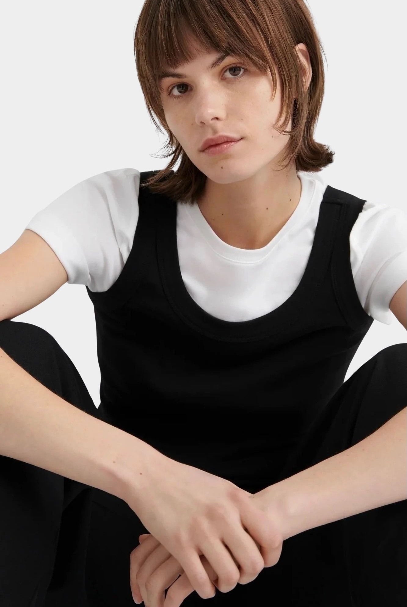 Kowtow Everyday Tank in black close up portrait view showing scoop neckline and wide straps