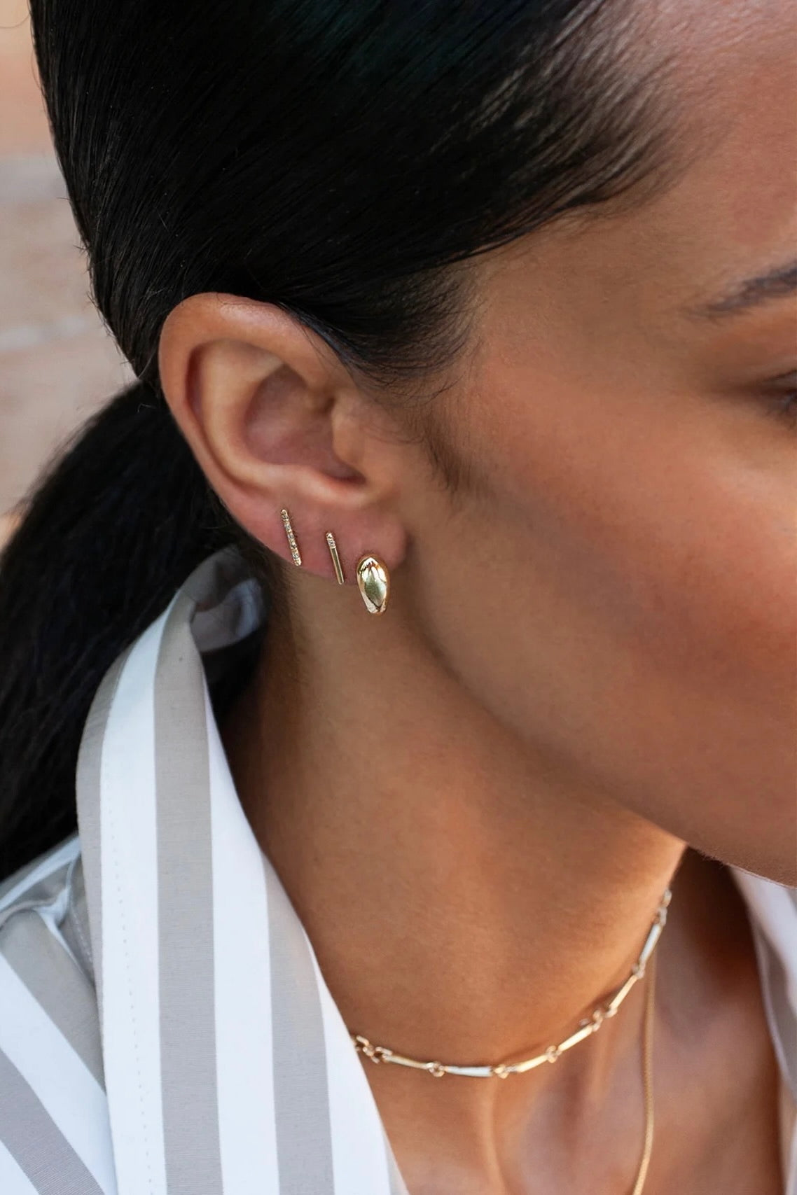 Model wearing 14K gold pavé diamond bar stud earring.