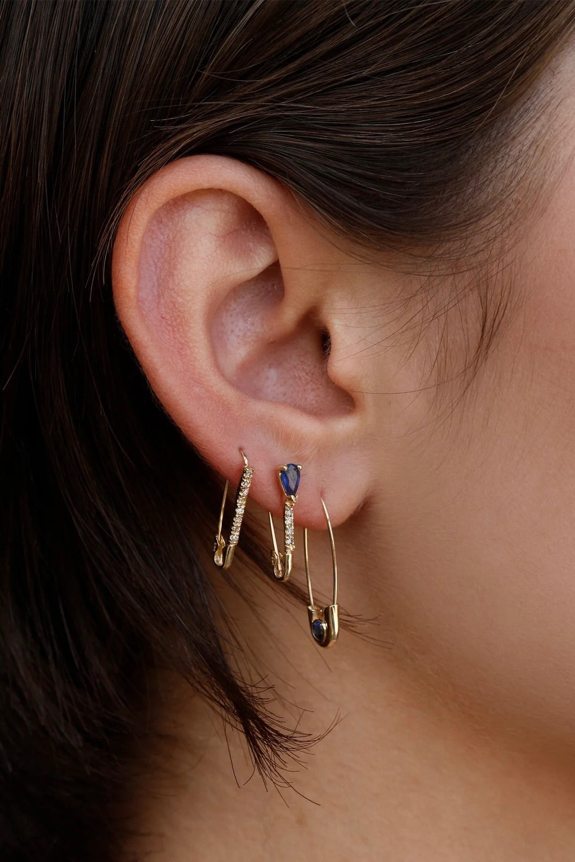 Model wearing 14K gold diamond and sapphire drop hoop earrings.