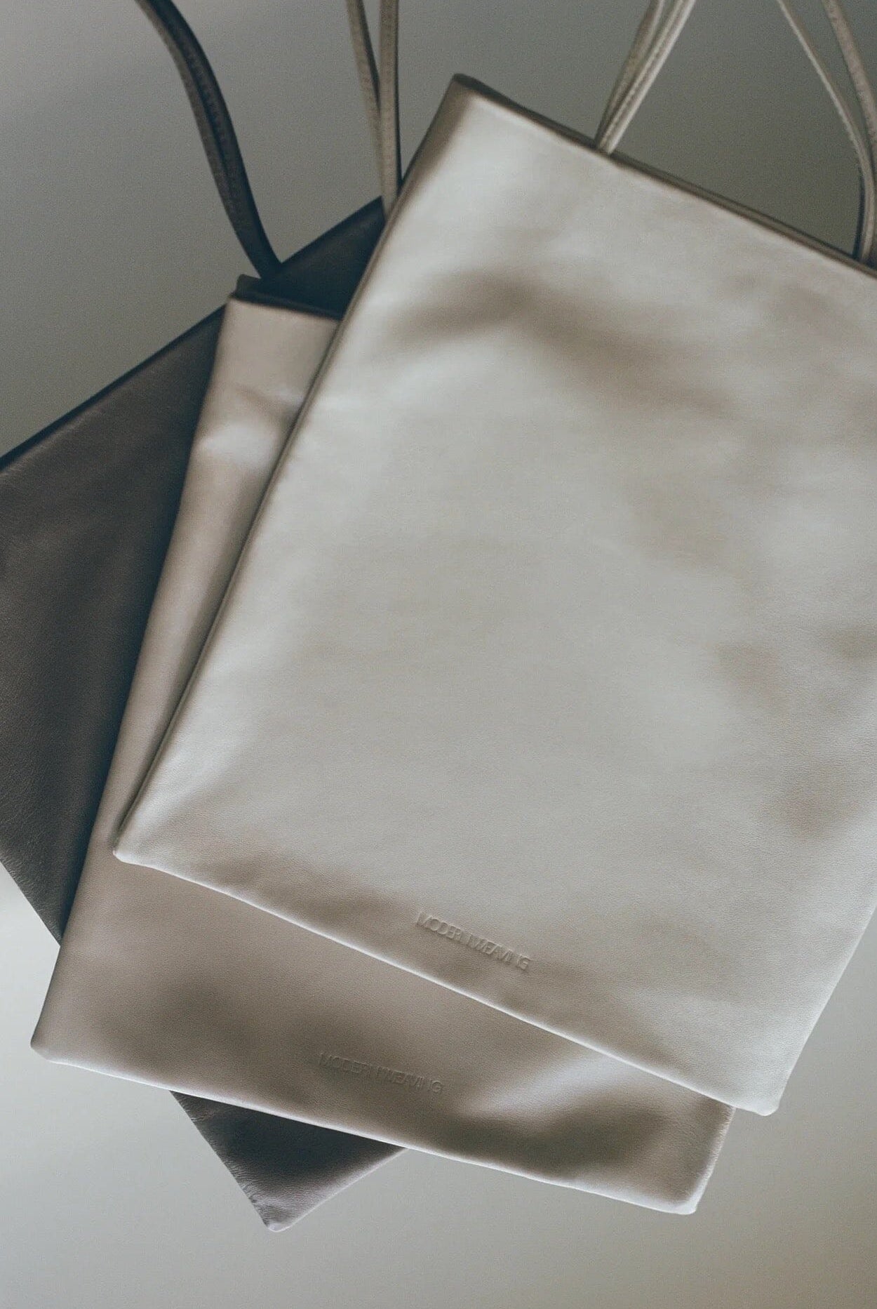 Modern Weaving | Slim Lamb Sak In Taupe - SHOP YUCCA Handbags MODERN WEAVING - YUCCA, Women’s clothing store Denver, women’s high quality bags, women’s online leather bags, minimalist leather bags.
