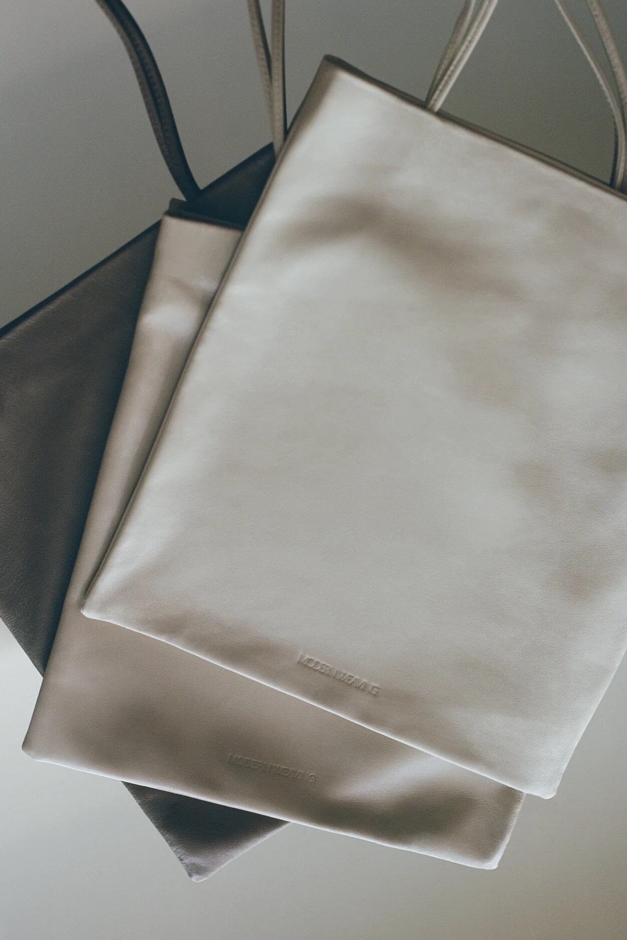 Modern Weaving | Slim Lamb Sak In Taupe - SHOP YUCCA Handbags MODERN WEAVING - YUCCA, Women’s clothing store Denver, women’s high quality bags, women’s online leather bags, minimalist leather bags.