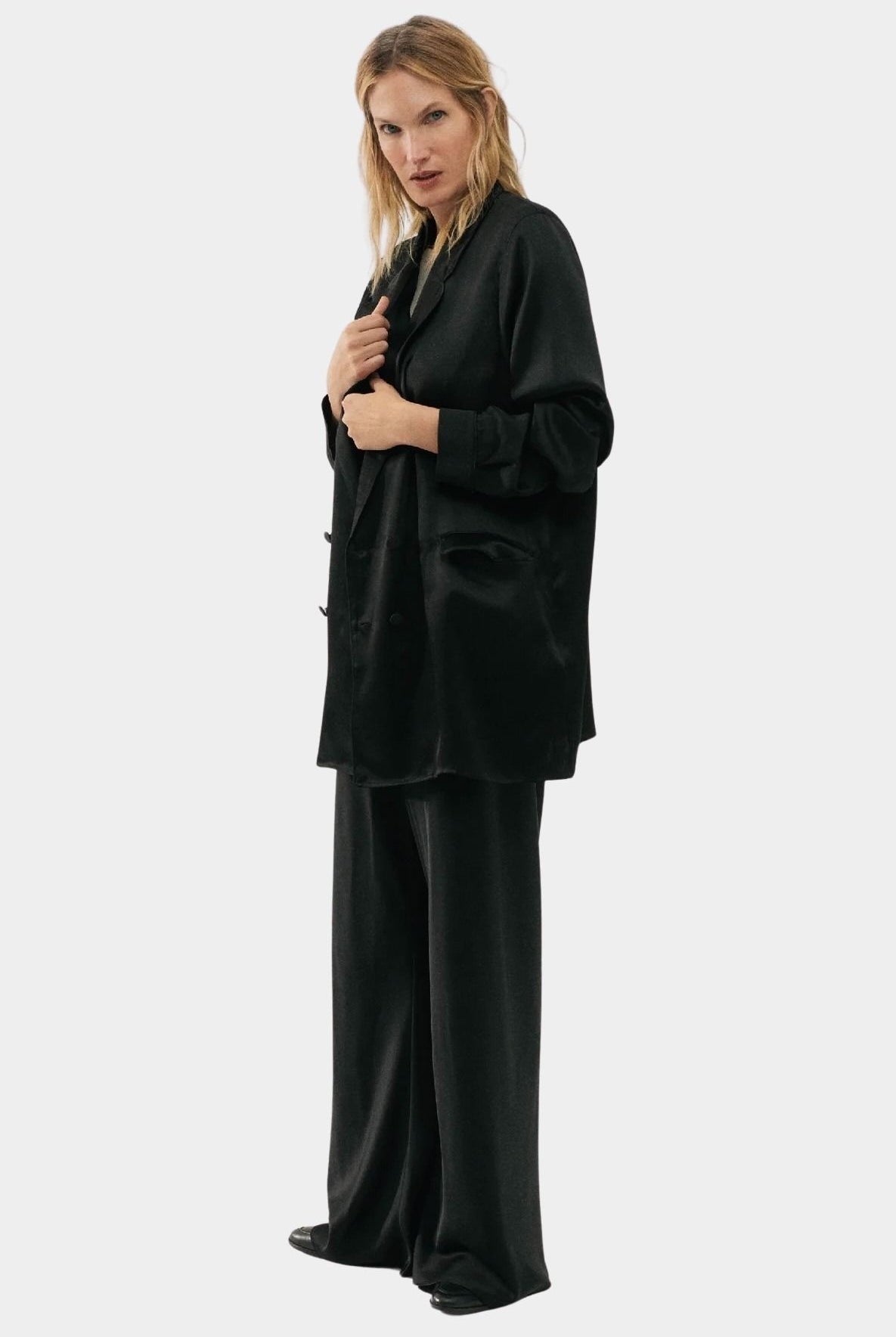 Silk Laundry black silk relaxed blazer worn open with matching trousers