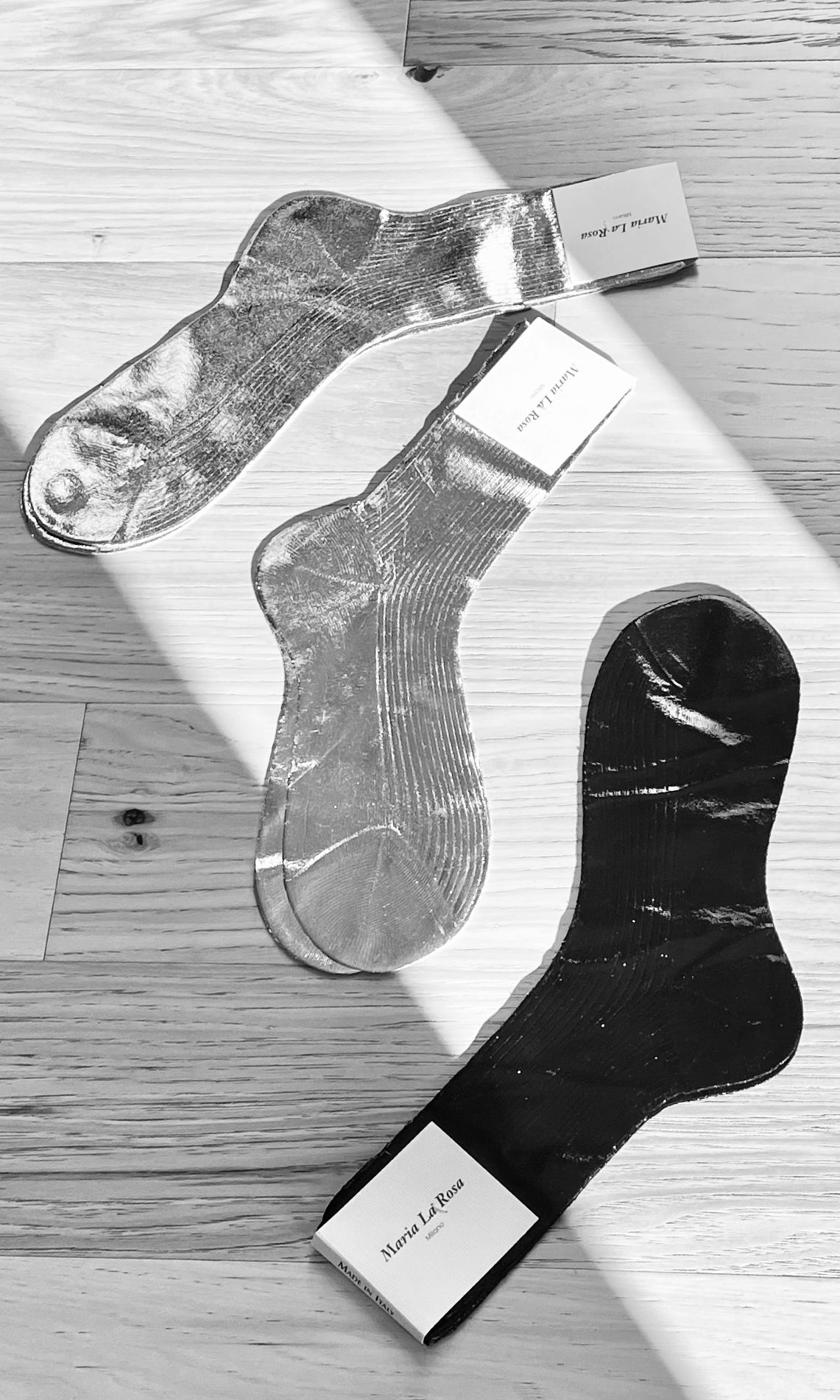 Maria La Rosa Italian metallic and silk ribbed knit socks styled on wood surface