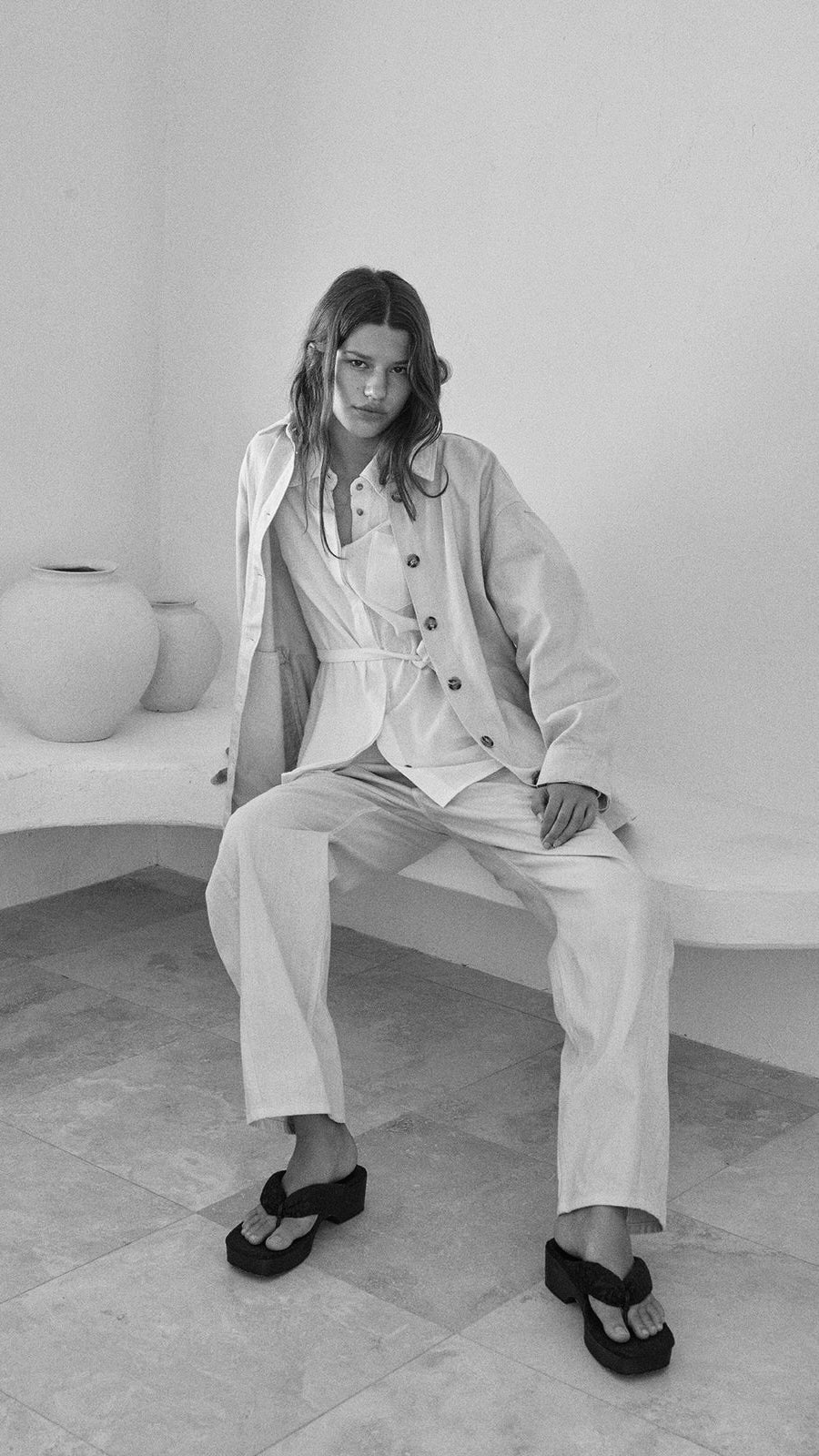 Atelier Delphine model wearing relaxed knitwear and tailored trousers