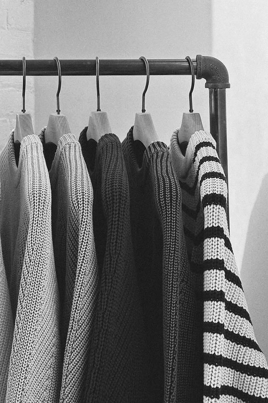 Demylee knit sweaters hanging on clothing rack