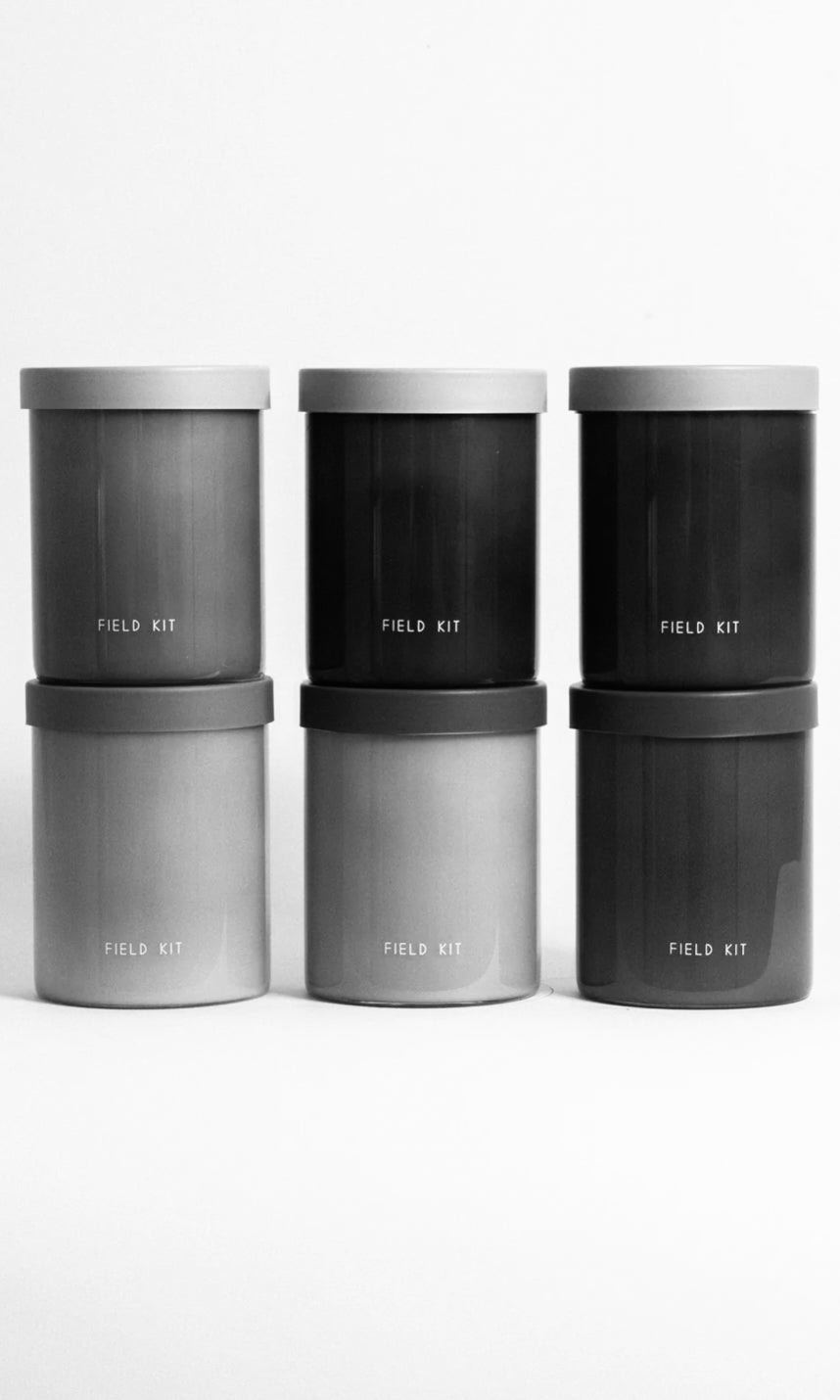 Field Kit soy candles in minimalist matte vessels stacked in neutral tones