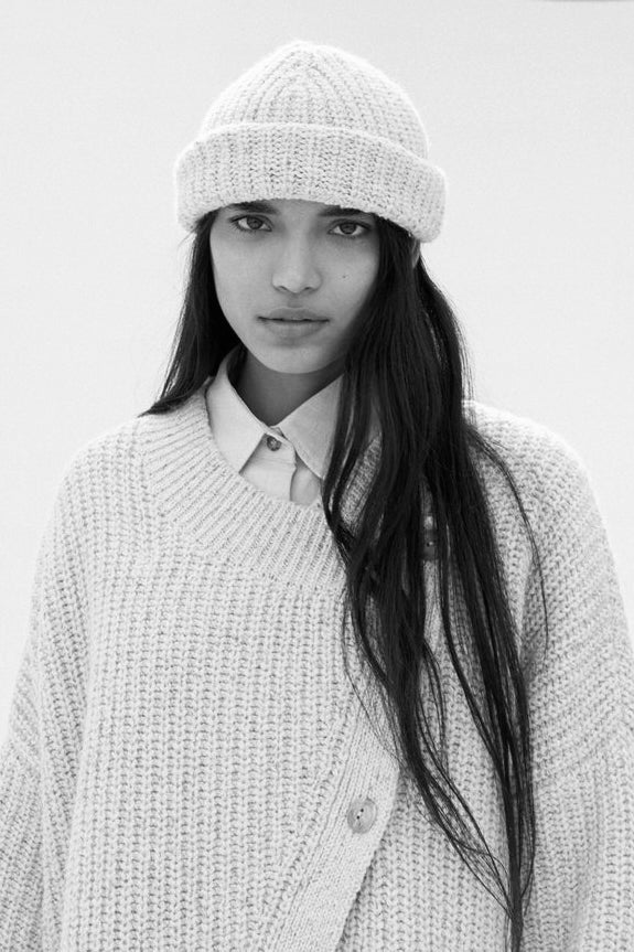 Women’s hats in neutral tones displayed on clean studio backgrounds