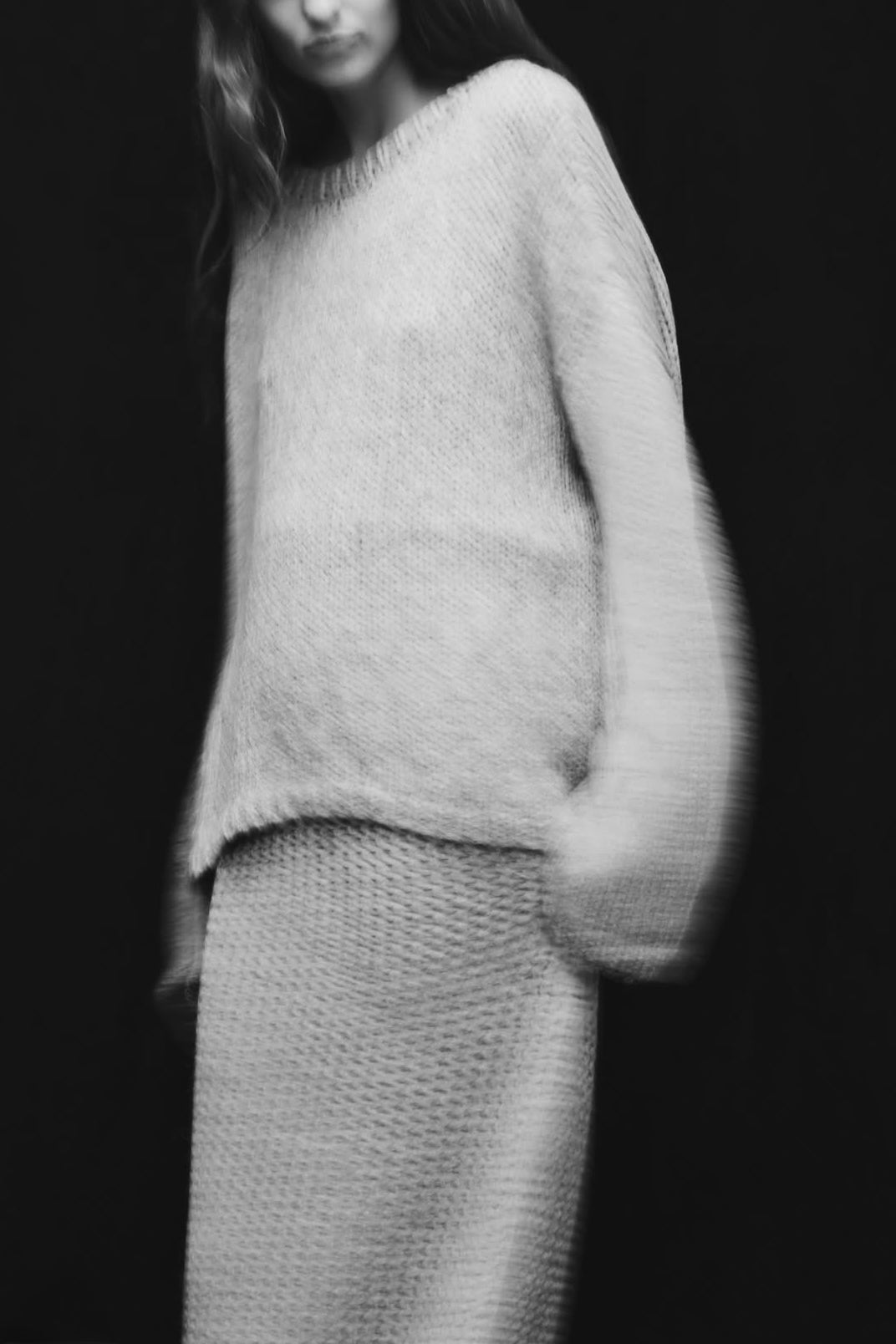 Black and white portrait of a Rachel Comey model wearing textured knit and tailored skirt.