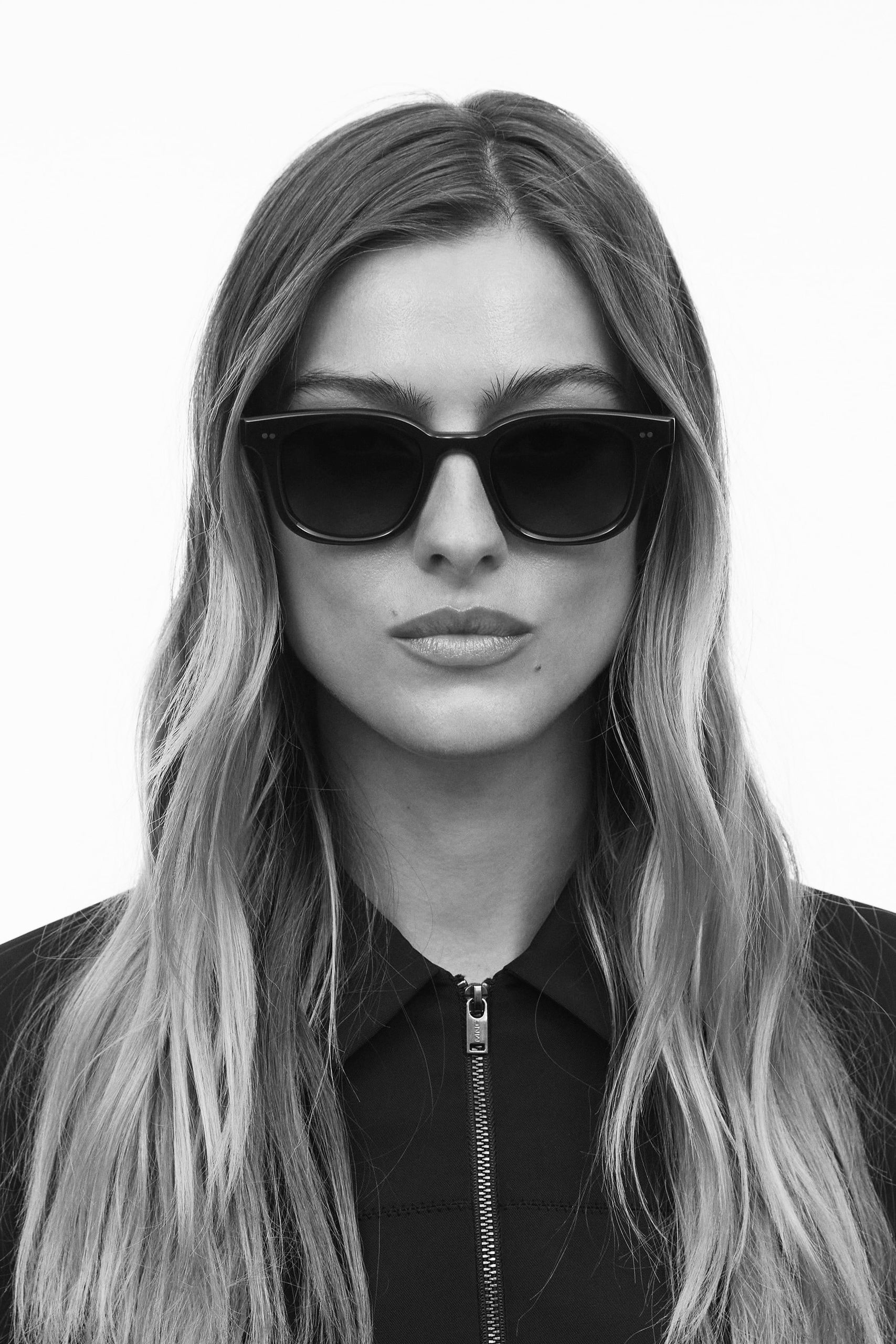 Woman wearing black CHIMI sunglasses with a classic square frame