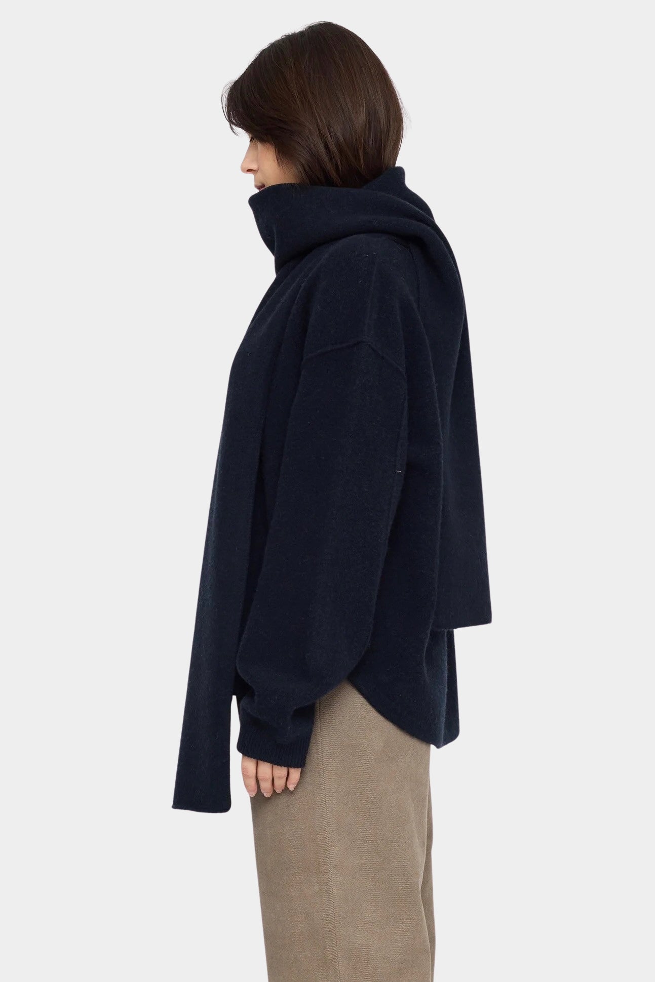 Side view of the Navy Black Long Wool Scarf wrapped around the neck with one end draped down the back