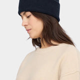 7115 by Szeki Merino Beanie Navy Black worn with a folded cuff, shown from the side at YUCCA Denver.