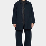 7115 by Szeki Mid-Length Chore Coat Navy front view worn open over a shirt at YUCCA Denver.