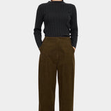 7115 by Szeki Mock Neck Ribbed Long Sleeves Charcoal tucked into brown corduroy trousers.
