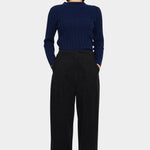 7115 by Szeki Mock Neck Ribbed Long Sleeves Navy tucked into black trousers with mock neckline visible.
