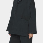 7115 by Szeki oversized cotton twill blazer charcoal black relaxed fit drop shoulder button front workwear jacket angled front view
