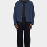 Front view of the navy 7115 by Szeki Relaxed Pocket Shirt worn open over a black tee at YUCCA Denver