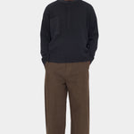 Front view of the black 7115 by Szeki Relaxed Pocket Sweater with brown trousers at YUCCA Denver