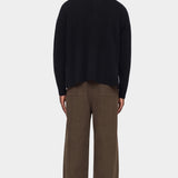 Back view of the black Relaxed Pocket Sweater showing its dropped shoulders and relaxed shape