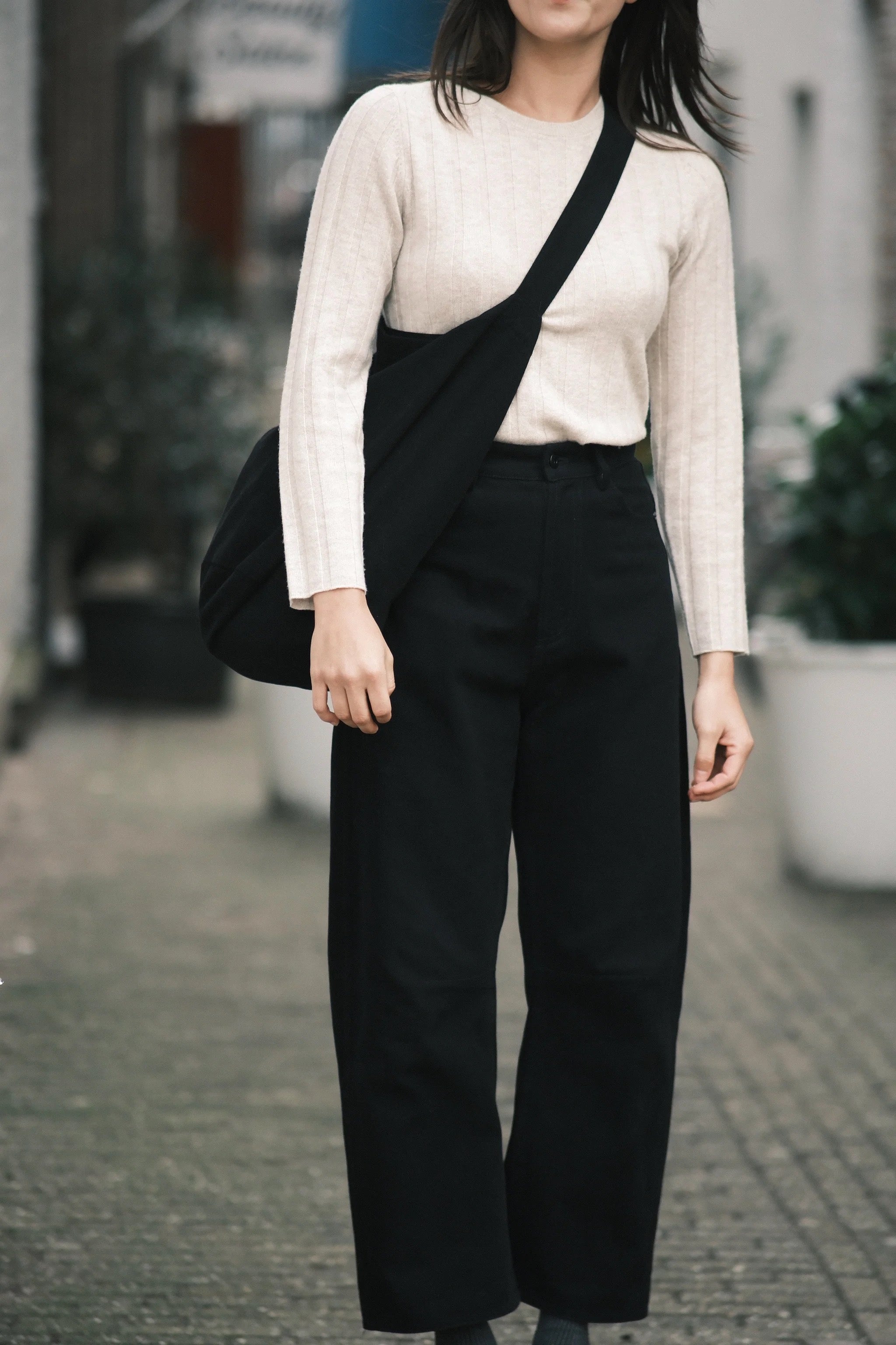 Front detail of the black Signature Curve Legged Work Trouser showing its fixed waist and curved leg at YUCCA Denver