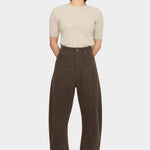 Front view of the Taupe Brown curved leg trouser styled with a cream short sleeve knit at YUCCA Denver