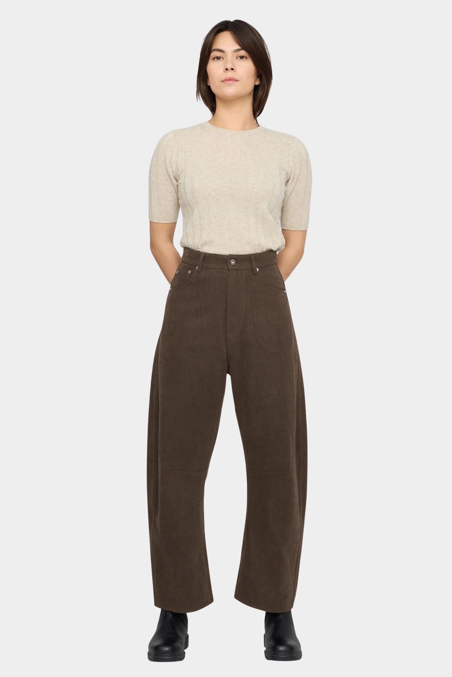Front view of the Taupe Brown curved leg trouser styled with a cream short sleeve knit at YUCCA Denver