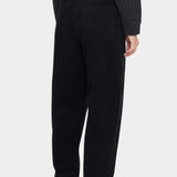 Front view of the black Signature Elastic Pull-Up Trouser with a rounded leg and tapered ankle at YUCCA Denver