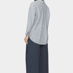 Back and side view of navy striped dolman shirt with split collar, inverted box pleat, and rounded high low hem