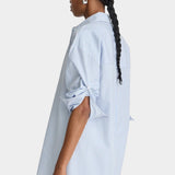 Apiece Apart Isolde Button Down Blue and White Stripes side profile with rolled sleeves and oversized fit