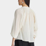 Back view of Apiece Apart Lo Campo Shirt Cream with gathered detailing and relaxed drape