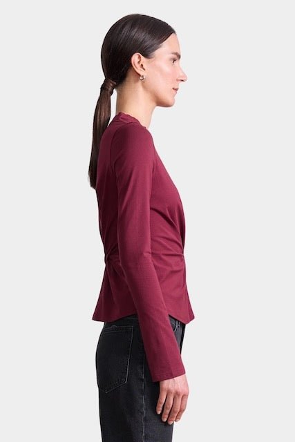Apiece Apart Long Sleeve Volta Top in Black Cherry with twist front detail styled with black trousers at YUCCA Denver