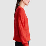 Apiece Apart Softest Tissue Weight Sweater in Tigerlily red cashmere silk knit styled with black trousers at YUCCA Denver