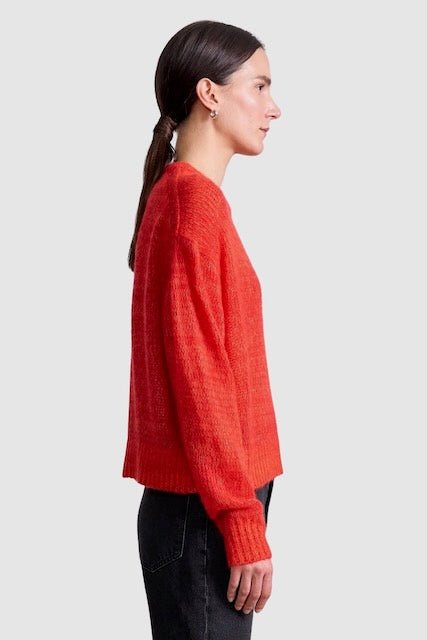 Apiece Apart Softest Tissue Weight Sweater in Tigerlily red cashmere silk knit styled with black trousers at YUCCA Denver