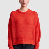 Apiece Apart Softest Tissue Weight Sweater in Tigerlily red cashmere silk knit styled with black trousers at YUCCA Denver