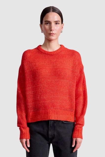 Apiece Apart Softest Tissue Weight Sweater in Tigerlily red cashmere silk knit styled with black trousers at YUCCA Denver