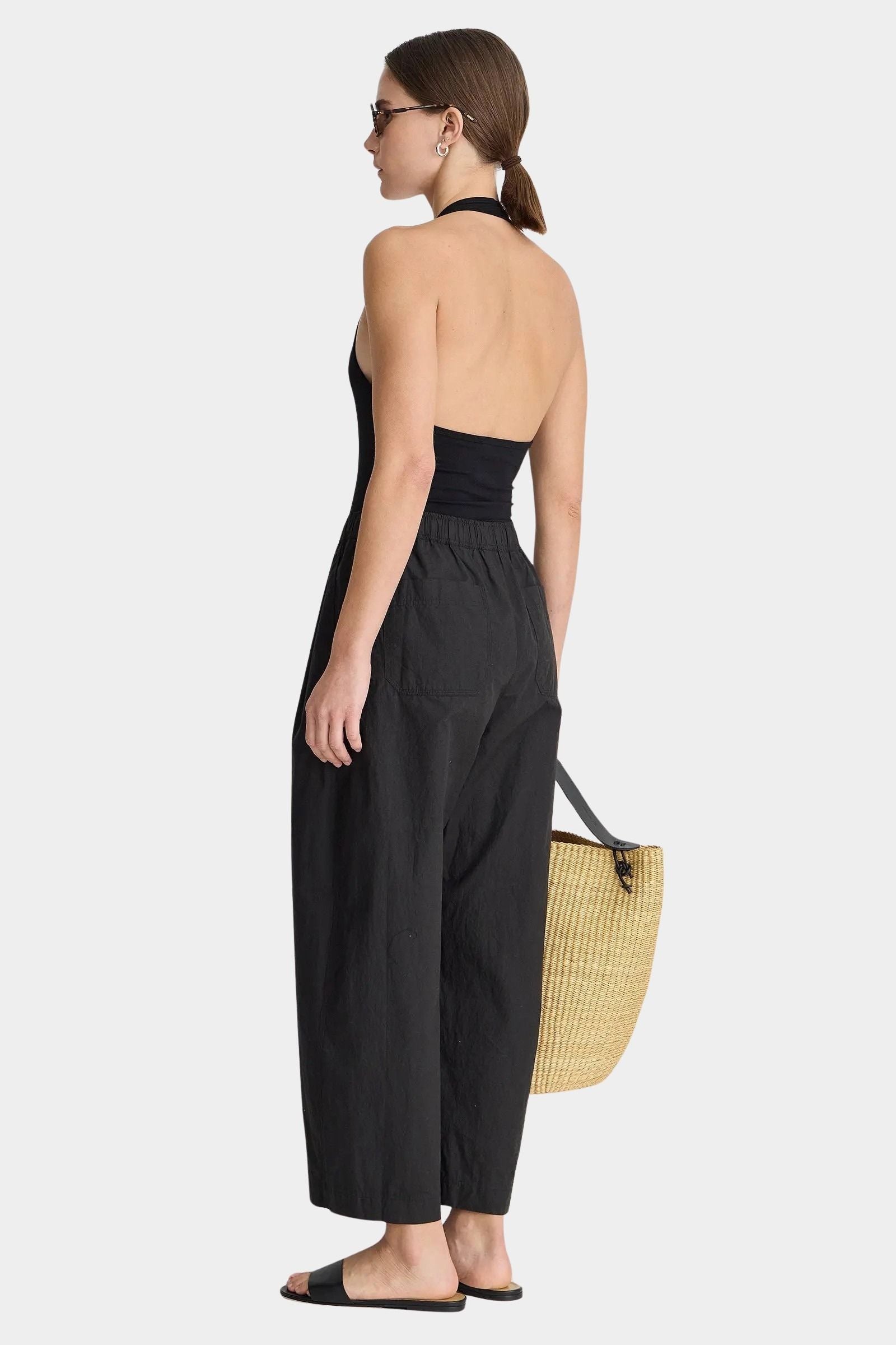 Back view of Apiece Apart Spa Pleat Pant Black with relaxed drape and easy volume through the leg
