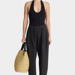 Apiece Apart Spa Pleat Pant Black relaxed cotton pull-on pant styled with halter bodysuit and woven tote at YUCCA Denver