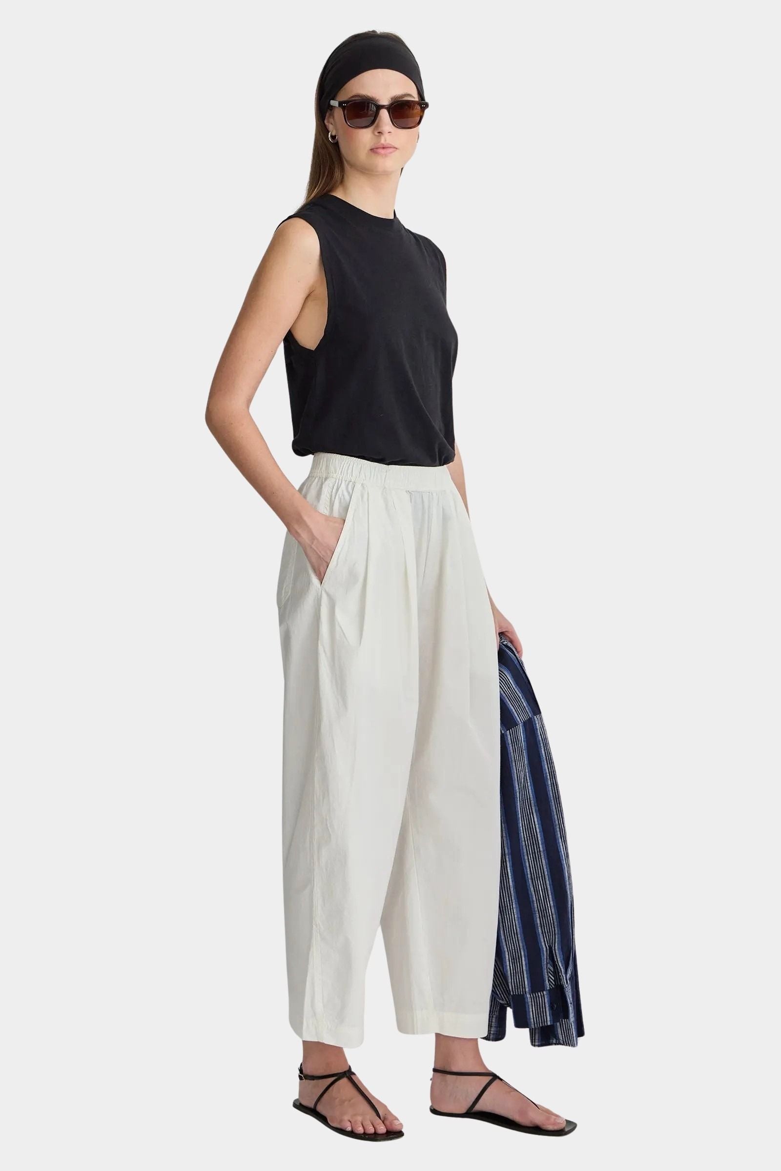 Apiece Apart Spa Pleat Pant Cream angled side view with relaxed cropped fit and organic cotton texture
