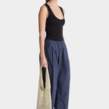 Apiece Apart Spa Pleat Pant Navy angled side profile with easy pull-on waistband and softly structured barrel leg silhouette