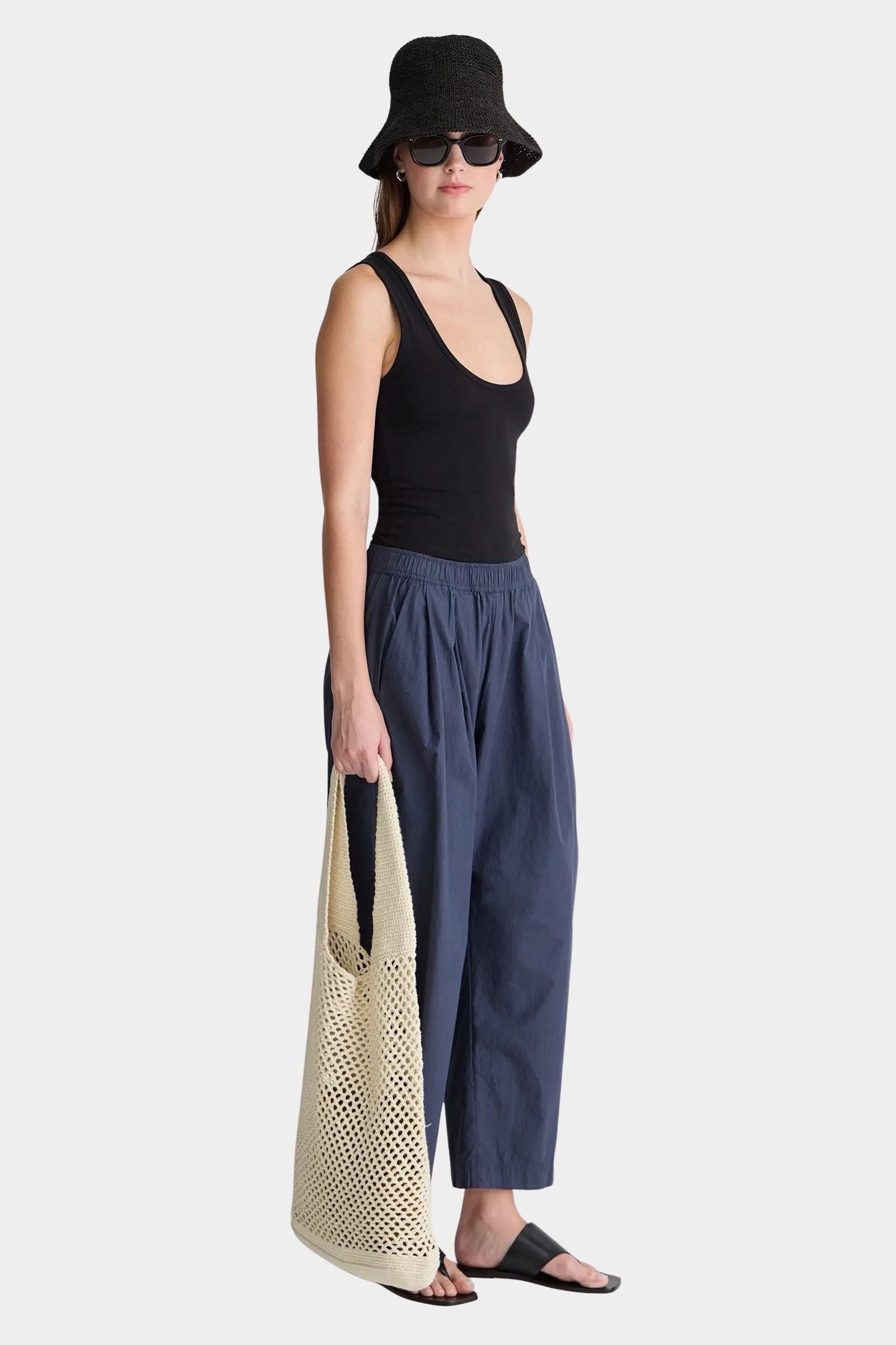 Apiece Apart Spa Pleat Pant Navy angled side profile with easy pull-on waistband and softly structured barrel leg silhouette