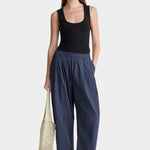 Apiece Apart Spa Pleat Pant Navy front styling view with elastic waist barrel leg silhouette and relaxed organic cotton fit