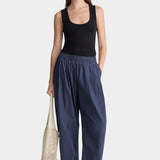 Apiece Apart Spa Pleat Pant Navy front styling view with elastic waist barrel leg silhouette and relaxed organic cotton fit